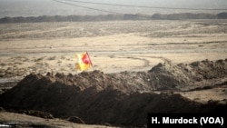 Formerly IS-controlled parts of Iraq are checkered with front lines as militants move back towards Tal Afar and Mosul, with this line marked with a Hashd Shaabi flag in the West where the pre-dominately Shia fighting force leads the charge, near Delawaya, Iraq, Dec. 17, 2016.