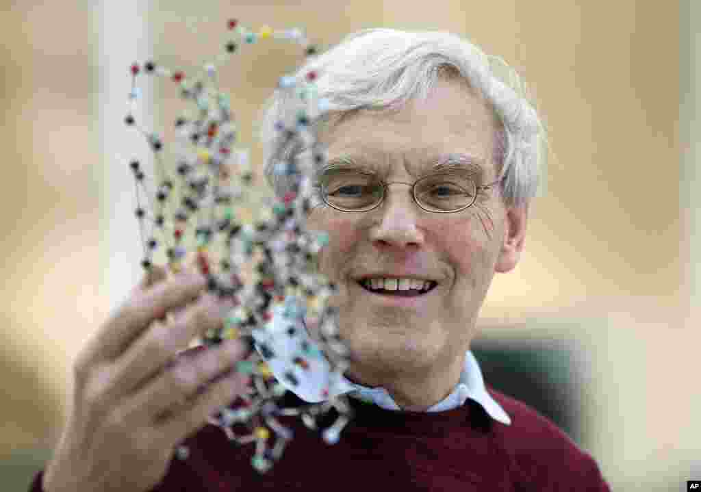 Richard Henderson, one of the 2017 Nobel Prize winners in Chemistry, holds a bacterio rhodopsin model at the Laboratory of Molecular Biology in Cambridge, England. Three researchers based in the U.S., U.K. and Switzerland won the Nobel Prize in Chemistry for developments in electron microscopy.