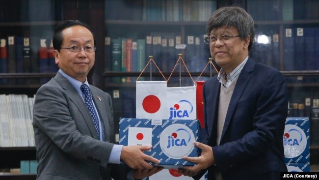 Ông Konaka Tetsuo (trái), Trưởng văn phòng đại diện JICA ở Việt Nam, trao tặng vật phẩm hỗ trợ chống COVID-19 cho ông Đặng Đức Anh, Viện trưởng Viện Vệ sinh Dịch tễ Trung ương.