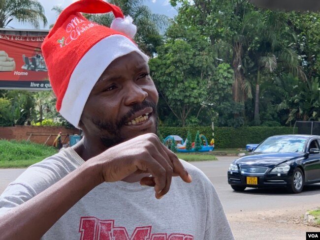 Forty-year-old Clive Mushayi became a street vendor four years ago after losing his job as an automobile mechanic. He says he cannot afford to go to his rural home east of Harare to be with his relatives this Christmas, Dec. 23, 2018. (C. Mavhunga for VOA)