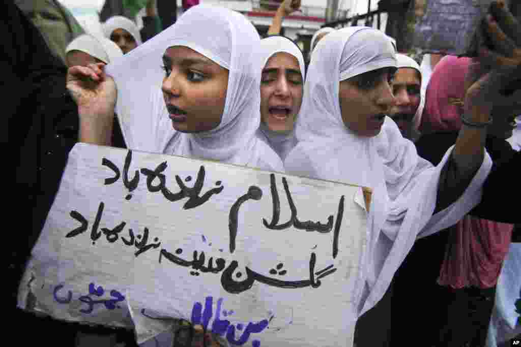 Indian Muslim girls shout slogans during a protest against an anti-Islam film called "Innocence of Muslims" that ridicules Islam's Prophet Muhammad in Jammu, India, Sept. 17, 2012. The placard in Urdu reads " Long live Islam."