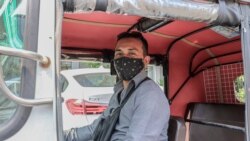 Tuk tuk driver Dorn Dy, 40, is doing his part to prevent the spread of the Coronavirus by providing customers with hand sanitizer during their rides, Phnom Penh, Cambodia, March 28, 2020. (Phorn Bopha/VOA Khmer)