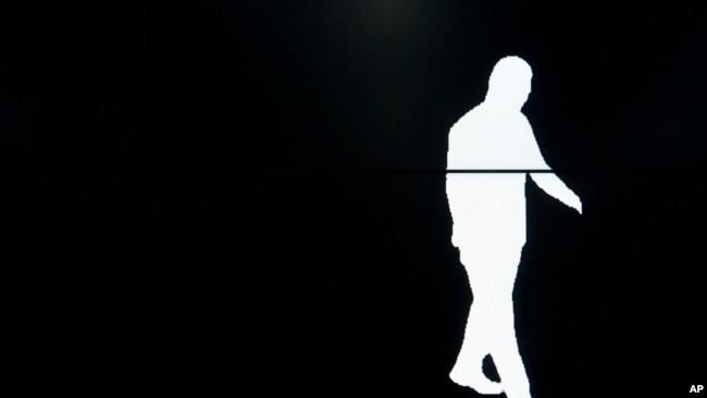 In this Oct. 31, 2018, photo, a screen displays a computer-generated image of a Watrix employee walking during a demonstration of their firm's gait recognition software at their company's offices in Beijing, China. (AP Photo/Mark Schiefelbein)