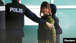 Vietnamese Doan Thi Huong who is on trial for the killing of Kim Jong Nam, the estranged half-brother of North Korea's leader, is escorted as she arrives at the Department of Chemistry in Petaling Jaya, near Kuala Lumpur, Malaysia October 9, 2017. 