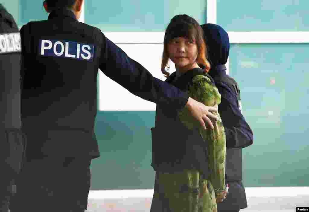 Vietnamese Doan Thi Huong who is on trial for the killing of Kim Jong Nam, the estranged half-brother of North Korea&#39;s leader, is escorted as she arrives at the Department of Chemistry in Petaling Jaya, near Kuala Lumpur, Malaysia.