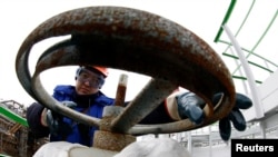 FILE - An employee works at the Bashneft-Novoil refinery in the city of Ufa, Russia, in this April 11, 2013. 