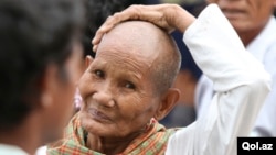 A Cambodian gestures outside the Extraordinary Chambers in the Courts of Cambodia (ECCC) courtroom during the trial of former Khmer Rouge leaders on the outskirts of Phnom Penh Jan. 10, 2012.