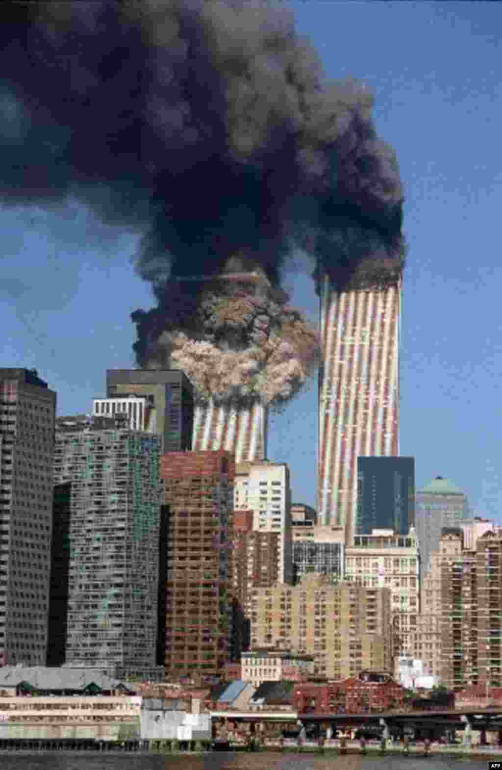 The south tower collapses as smoke billows from both towers of the World Trade Center, in New York, Tuesday, Sept. 11, 2001. In one of the most horrifying attacks ever against the United States, terrorists crashed two airliners into the World Trade Center