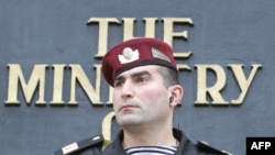 FILE - An Azeri policeman is seen guarding the entrance to Azerbaijan's Interior Ministry building in downtown Baku.