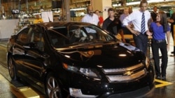 President Obama looks at a newly built Chevy Volt during a visit to a GM factory in Hamtramck, Michigan, in July