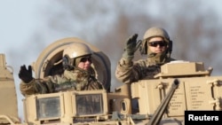 U.S. soldiers are seen atop a military vehicle deployed in Latvia, in Riga. (Nov. 18, 2014)