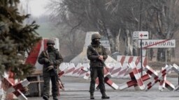 Ukrainian soldiers stand on a check-point close to the line of separation from pro-Russian rebels, Mariupol, Donetsk region, Jan. 21, 2022.