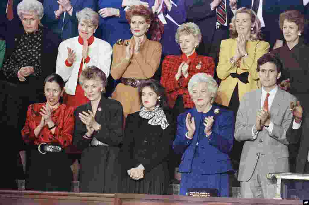 Barbara Bush, center is joined by Margaret and Marvin Bush as they applaud President Bush's arrival to the House chamber Wednesday, Jan. 31, 1990.