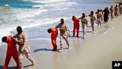 This undated image made from video released by Islamic State militants April 19, 2015, purports to show a group of captured Ethiopian Christians taken to a beach before being executed.