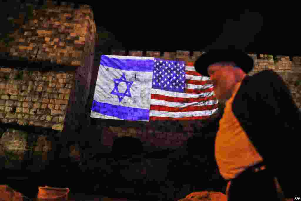 A giant U.S. flag screened alongside Israel&#39;s national flag by the Jerusalem municipality on the walls of the old city. U.S. President Donald Trump recognized the disputed city of Jerusalem as Israel&#39;s capital and kicked off the process of relocating the U.S. embassy there from Tel Aviv.