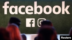 FILE - A Facebook logo is seen at the Facebook Gather conference in Brussels, Belgium, Jan. 23, 2018.