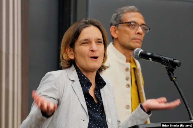 FILE - Abhijit Banerjee and Esther Duflo, two of the three winners of the 2019 Nobel Prize in Economics, speak at news conference at the Massachusetts Institute of Technology (MIT) in Cambridge, Massachusetts, U.S., October 14, 2019. (REUTERS/Brian Snyder/File Photo)