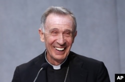 FILE - Monsignor Luis Francisco Ladaria Ferrer smiles during a news conference at the Vatican, Sept. 8, 2015. Pope Francis has tapped Ferrer to lead the powerful congregation that handles sex abuse cases and guarantees Catholic orthodoxy around the world.