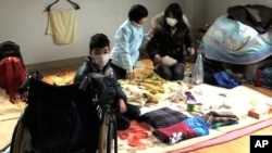 Mugen Takahashi, 11, with his sister and mother. Despite being in a wheelchair, Mugen managed to escape the tsunami.