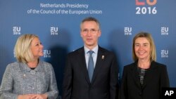 NATO Secretary General Jens Stoltenberg, center, is flanked by EU High Representative Federica Mogherini, right, and Netherlands’ Defense Minister Jeanine Hennis-Plasschaert in Amsterdam, Netherlands, Feb. 5, 2016. 