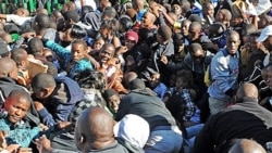 Thousands of parents and young students seeking to attend the University of Johannesburg push their way into the gates on January 10, causing a stampede. One person was killed and at least 20 injured.