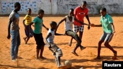 Children play soccer in Maputo, Mozambique, Nov.16, 2013. 