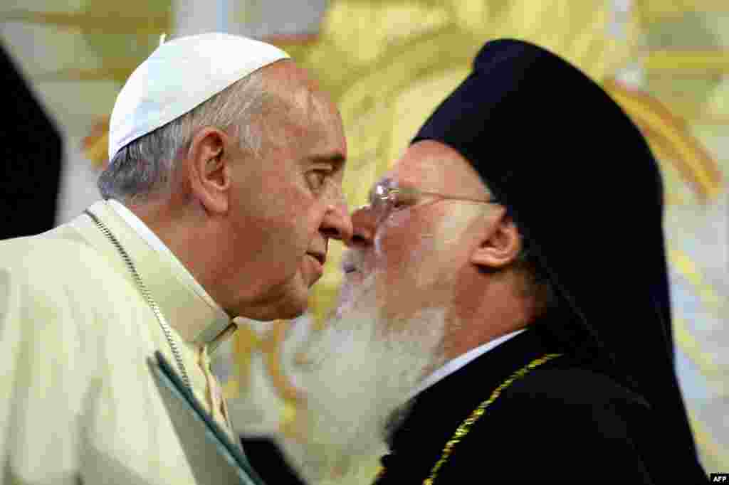 Pope Francis (L) kisses Ecumenical Patriarch Bartholomew I after they signed a joint statement at St. George Church, the principal Greek Orthodox cathedral in Istanbul as part of a three-day visit in Turkey.
