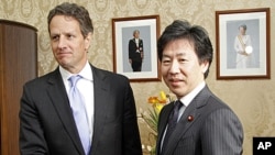 U.S. Treasury Secretary Timothy Geithner, left, shakes hands with his Japanese counterpart Jun Azumi prior to their meeting in Tokyo, January 12, 2012.