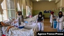 FILE - Female nurses takes care of patients at Wazir Akbar Khan hospital in Kabul, Afghanistan, Sept. 1, 2021.