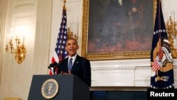 U.S. President Barack Obama talks about the humanitarian relief situation in Iraq inside the State Dining Room of the White House in Washington, August 7, 2014.