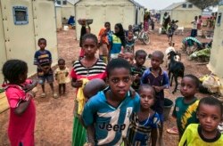 FILE - Children displaced by attacks gather in a makeshift camp for the displaced in Youba in Yatenga province in Burkina Faso, April 20, 2020.