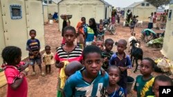 FILE - Children displaced by attacks gather in a makeshift camp for the displaced in Youba, Yatenga province, Burkina Faso, April 20, 2020.