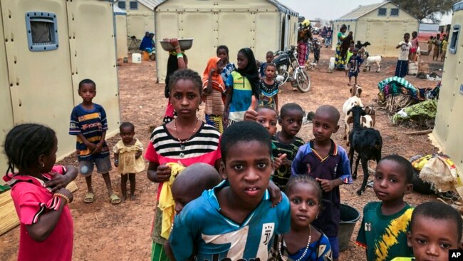 FILE - Children displaced by attacks gather in a makeshift camp for the displaced in Youba, Yatenga province, Burkina Faso, April 20, 2020.