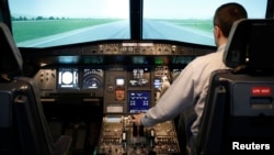 Gerhard Lueck, CEO of ViennaFlight, sits in the cockpit of an Airbus A320 flight simulator in Vienna, March 26, 2015. 