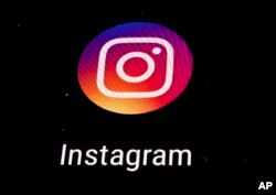 FILE - Instagram app logo is displayed on a mobile screen.