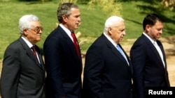 Palestinian Prime Minister Mahmoud Abbas, U.S. President George W. Bush, Israel's Prime Minister Ariel Sharon and Jordan's King Abdullah walk to the podium for their final statement at the end of a summit in Aqaba, June 4, 2003.