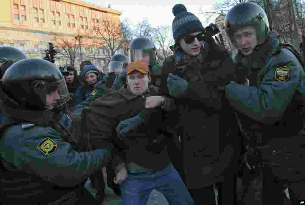 Police officers detain opposition activists during an unauthorized rally in Lubyanka Square in Moscow, Russia, Saturday, Dec. 15, 2012.