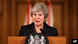 FILE - Britain's Prime Minister Theresa May speaks during a press conference inside 10 Downing Street in London, Nov. 15, 2018.