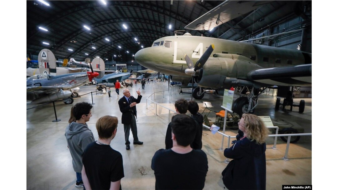 In this Friday, April 26, 2019 photo, visitors browse the D-Day displays at the The National Museum of the U.S. Air Force, in Dayton, Ohio.