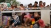 Cambodian migrant workers get off Thai truck upon arriving at international border crossing in Poipet, Cambodia, June 17, 2014.