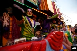 A rider throws beads as the Krewe of Endymion Mardi Gras parade rolls through New Orleans, Feb. 6, 2016.