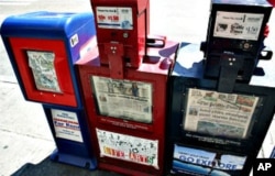 This photo of newsboxes was taken in Seattle when it had two daily papers. Now the one in the middle box, the "Post-Intelligencer", is gone.