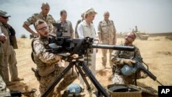 FILE - German Defense Minister Ursula von der Leyen speaks with German soldiers at Camp Castor near Gao, Mali, April 5, 2016. 