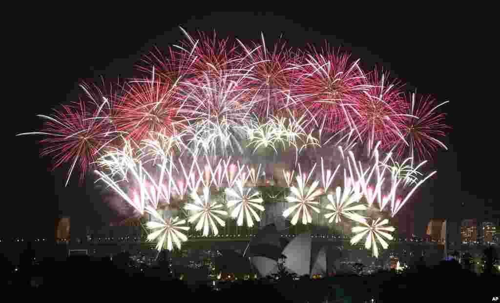 Fireworks explode over the Harbour Bridge and the Opera House during New Year&#39;s Eve celebrations in Sydney, Australia.