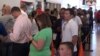 Voters in Houston, Texas, stand in line to cast their ballots early for the 2016 presidential election. (G. Flakus/VOA)