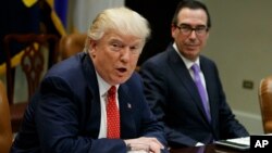 Treasury Secretary Steven Mnuchin listens as President Donald Trump speaks during a meeting on the Federal budget, Feb. 22, 2017, in the Roosevelt Room of the White House in Washington.