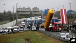 Truckers block the highway near Calais, northern France, Sept. 5, 2016. 