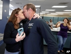 Former felon Brett DuVall, right, kisses his wife Dottie as they celebrate after he registered to vote at the Supervisor of Elections office, Jan. 8, 2019, in Orlando.