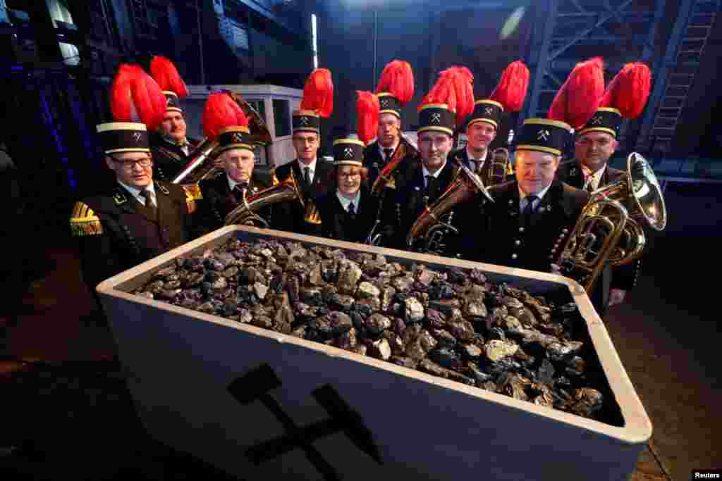 Miners&#39; brass band members pose for a picture as German RAG corporation brings up the last load of stone coal production at Von Oeynhausen mine in Ibbenbueren, western Germany, Dec. 4, 2018.