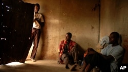 FILE - Illegal Zimbabwean immigrants who work as farm laborers are seen inside their room on a farm.